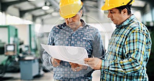 Team Of Engineers Having Discussion In Factory