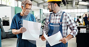 Team Of Engineers Having Discussion In Factory