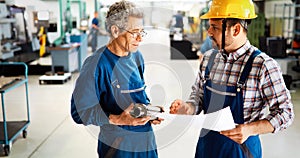 Team Of Engineers Having Discussion In Factory