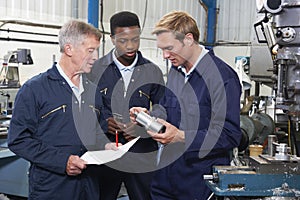 Team Of Engineers Having Discussion In Factory photo