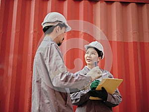 A team of engineers talks to managers at the Container cargo