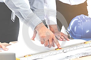 Team engineers working with construction tools on table