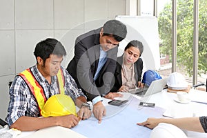 Team engineers working meeting room at the office. Three workers are talking construction plan. Electricians carpenter or Technica