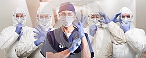 Team of Female and Male Doctors or Nurses Wearing Personal Protective Equipment In Hospital Hallway