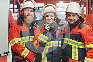 Team of fire fighters looking into camera