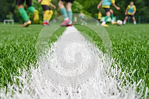 Team on football ground. Match training school soccer field lines. Young footballers on pitch playing football court