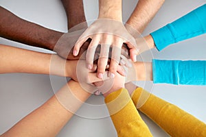Team of friends showing unity with their hands together