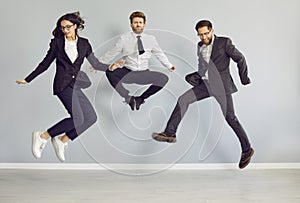 Team of funny, happy, crazy business people jumping and having fun in the office