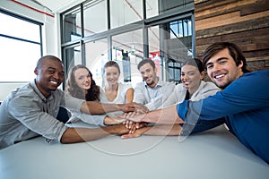 Team of graphic designers forming handstack