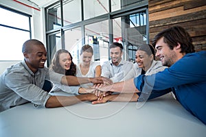 Team of graphic designers forming handstack