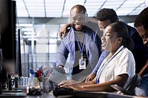 Team of happy engineers laughing in data center office photo