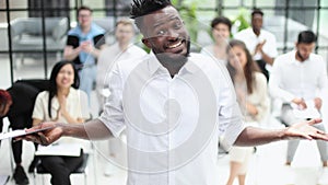 Team of happy male and female company workers applauding colleague in corporate meeting