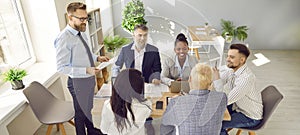 Team of happy multiracial business people having a corporate work meeting in the office