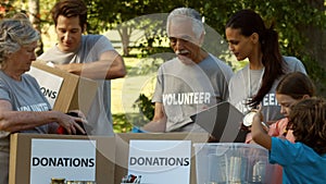 Team of happy volunteers collecting donations