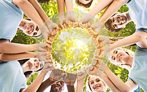 Team of happy volunteers fist bump together in park