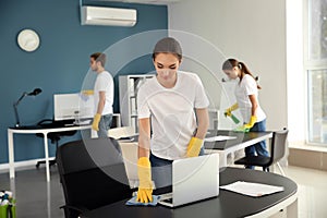 Team of janitors cleaning office