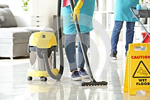 Team of janitors cleaning office