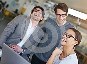 Team, laptop and happiness in office with laughing, cheerful and happy for company as colleagues. Businesspeople, group