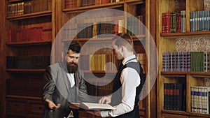 Team of lawyers in the law library at the university. Lawyers reading book and discussing in the law library at the