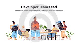 Team lead engineer with developers coding together development of software and programming concept