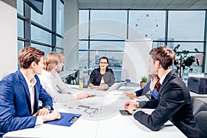 Team leader and business owner leading informal in-house business meeting