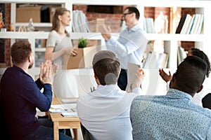 Team leader with colleagues applauding to just hired employee