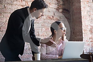 Team leader correcting offended employee at work.