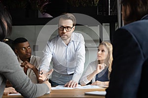 Team leader explains research result report statistical data to workmates