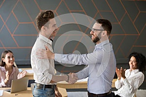 Team leader handshaking employee congratulating with professiona