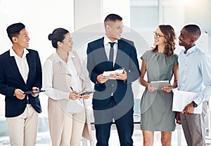 Team, leadership and business people standing in office talking, having conversation and discussion. Teamwork, diversity