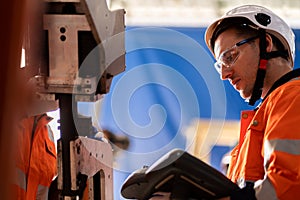 A team of male and female engineers meeting to inspect computer-controlled steel welding robots. Plan for rehearsals and