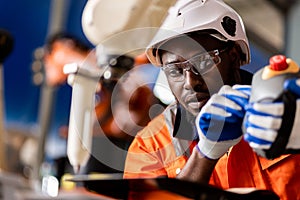 A team of male and female engineers meeting to inspect computer-controlled steel welding robots. Plan for rehearsals and