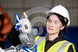 A team of male and female engineers meeting to inspect computer-controlled steel welding robots. Plan for rehearsals and