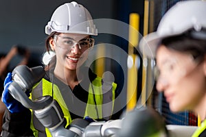 A team of male and female engineers meeting to inspect computer-controlled steel welding robots. Plan for rehearsals and