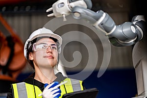 A team of male and female engineers meeting to inspect computer-controlled steel welding robots. Plan for rehearsals and