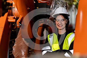 A team of male and female engineers meeting to inspect computer-controlled steel welding robots. Plan for rehearsals and