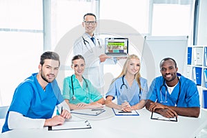 team of male and female nurses and general practitioner with laptop