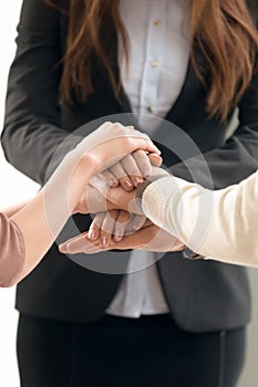 Team management concept, business people joining hands, vertical