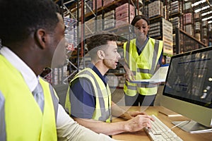 Team managing warehouse logistics in an on-site office