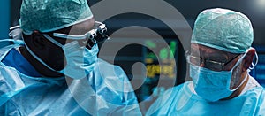 Team of medical doctors performs surgical operation in modern operating room using high-tech technology. Surgeons are