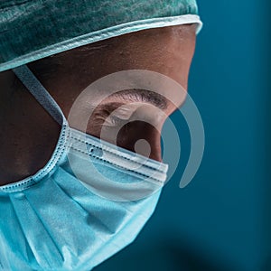 Team of medical doctors performs surgical operation in modern operating room using high-tech technology. Surgeons are