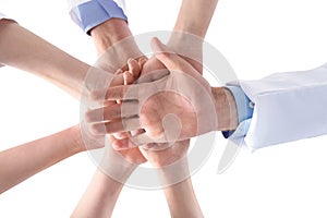 Team of medical doctors putting hands together on white background, closeup.