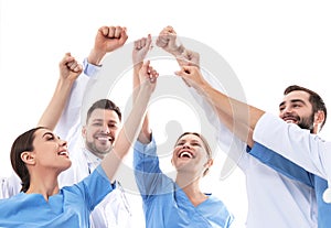 Team of medical doctors raising hands together. Unity concept