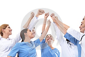 Team of medical doctors raising hands together on white background