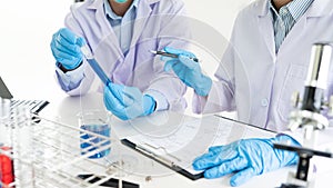 Team of Medical Research Scientists or researcher in lab coat testing their experimental in Modern laboratory