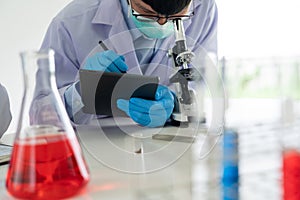 Team of Medical Research Scientists or researcher in lab coat testing their experimental in Modern laboratory