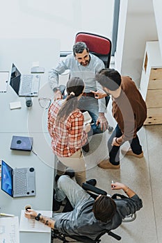 Team meeting discussion with laptops and documents in modern office.