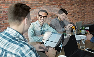 Programmers cooperating at IT company developing apps