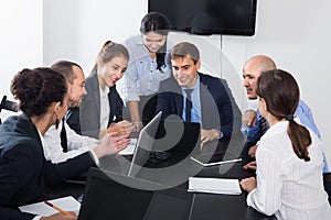 Team member explaining issue on project to coworkers