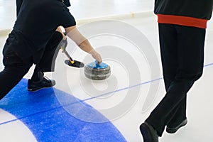 Team members play in curling